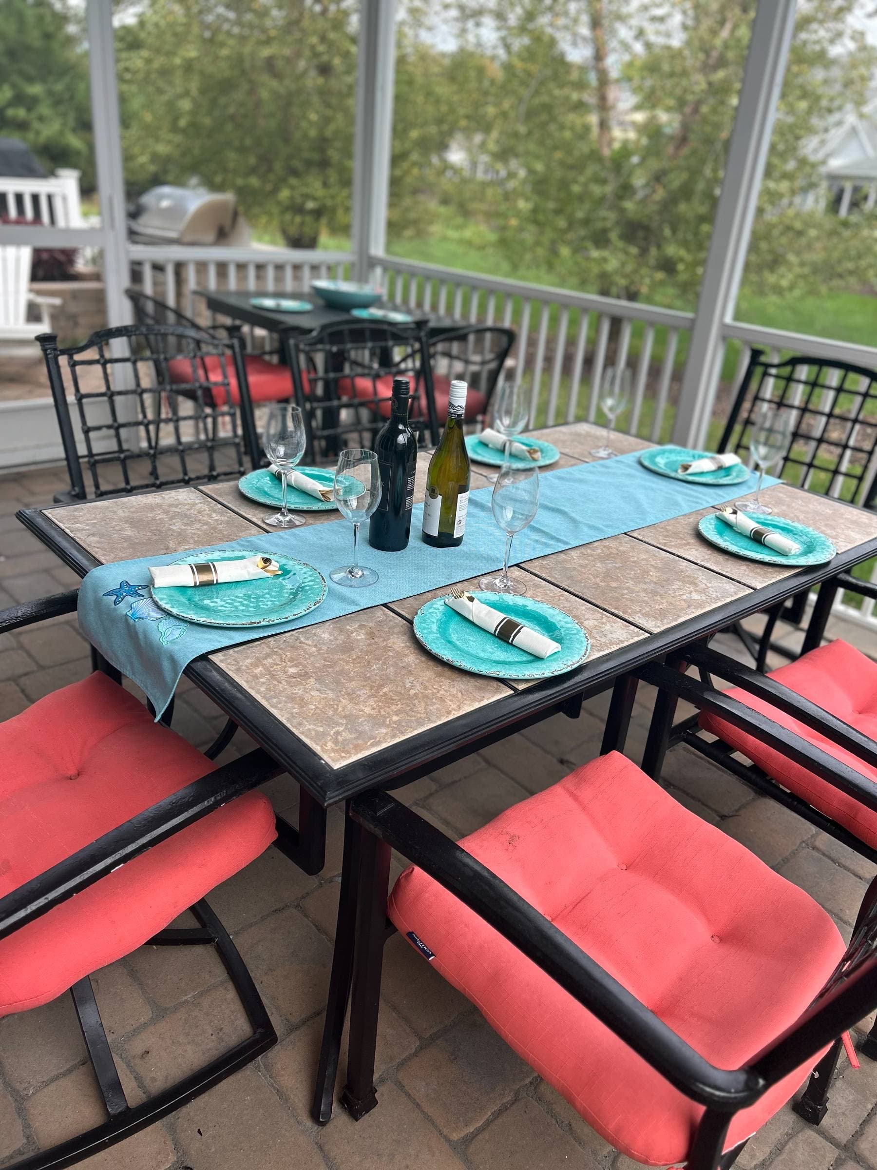 Step from the first-floor family room onto the screened porch and patio, perfect for barbecues, games, and gatherings. String lights create a warm and festive atmosphere.